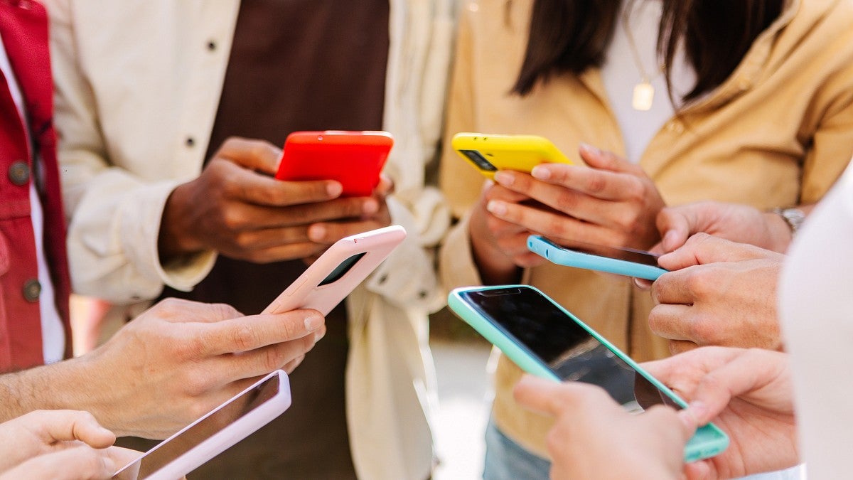 A group of people using cellphones