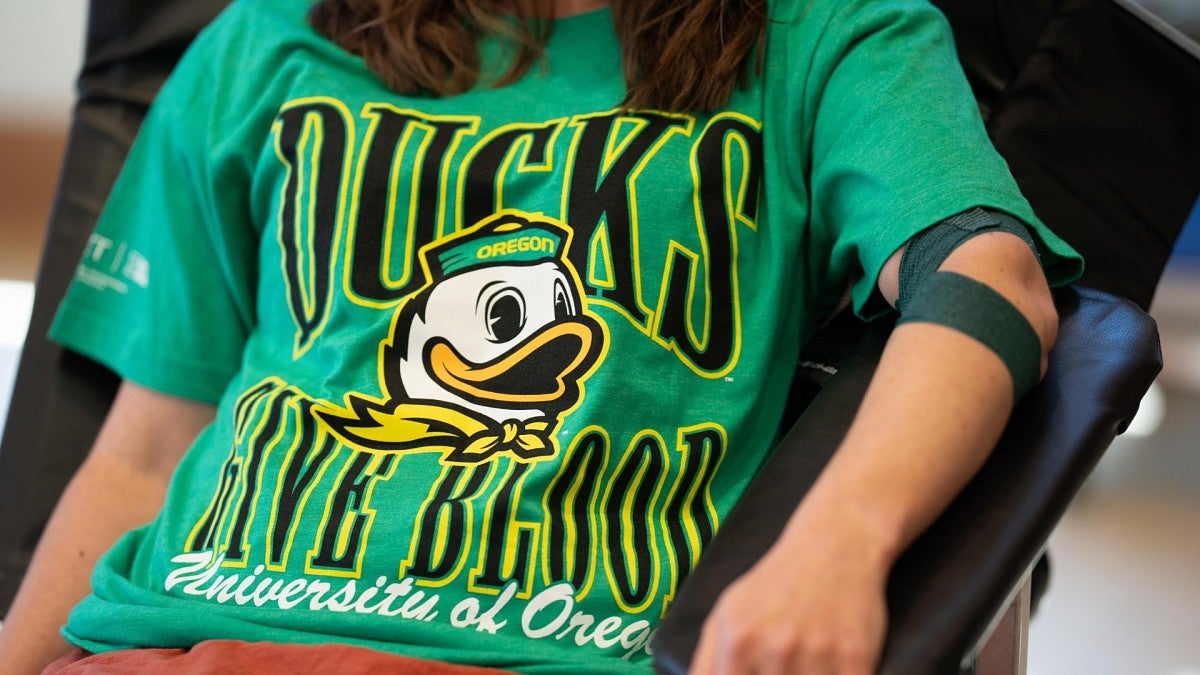 person donating blood wearing Ducks shirt