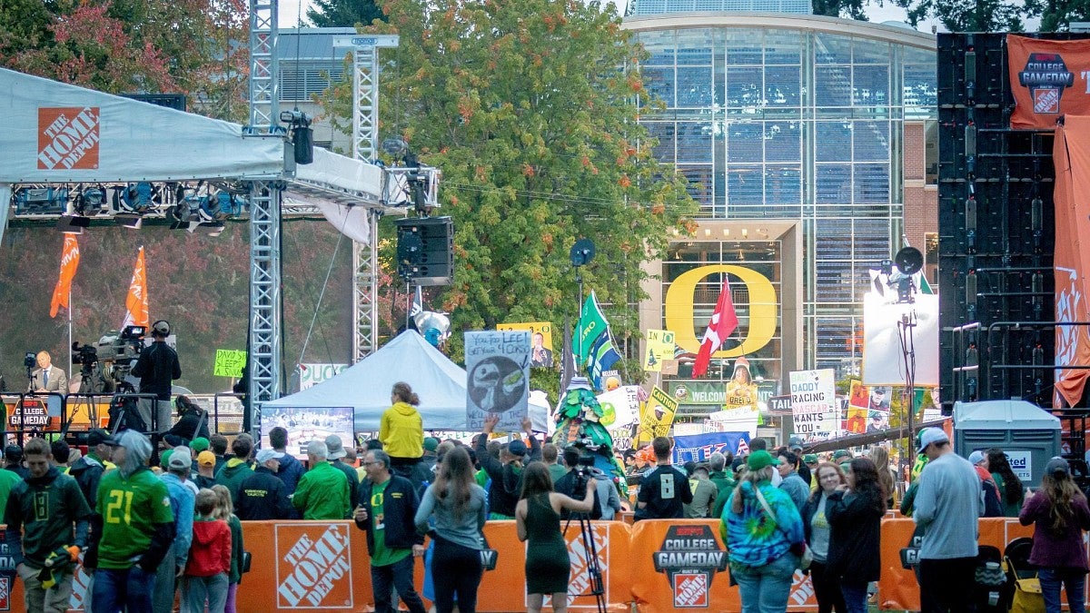 Duck fans gather in the memorial quad for a College GameDay broadcast with the iconic yellow O of Lillis Hall in the background
