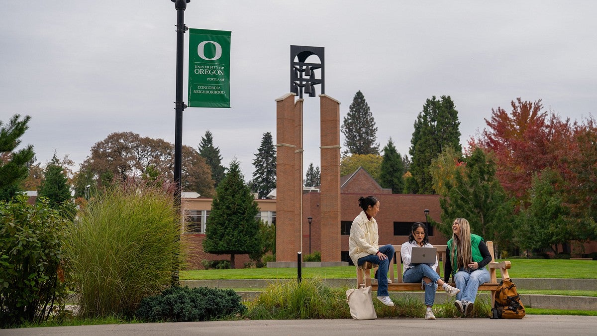 People on a bench on the UO Portland campus