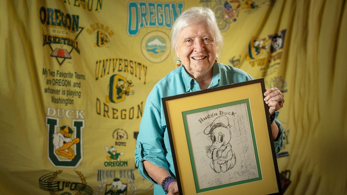 Claudine Lundgren holding a framed sketch