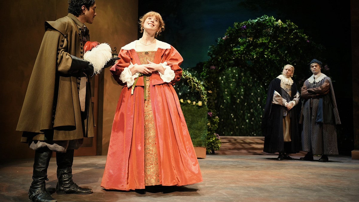 Students on stage in a production of Much Ado About Nothing