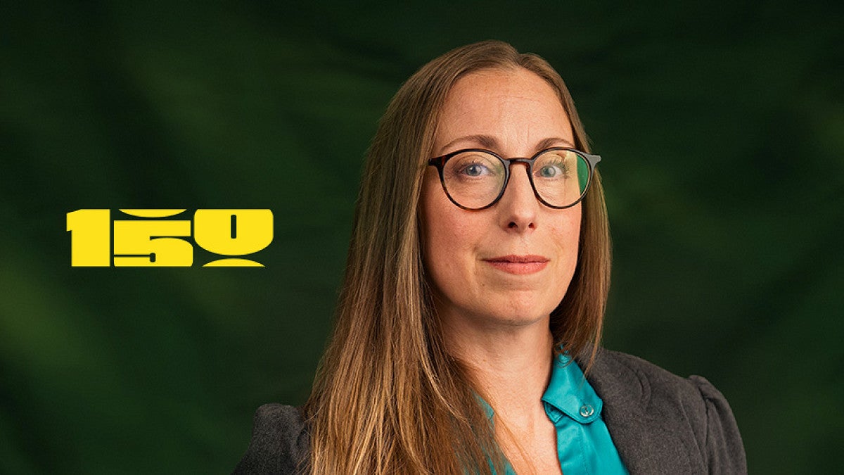 Autumn Shafer portrait with a yellow UO 150th logo