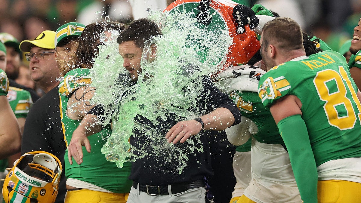 Football players pouring Gatorade over their coach