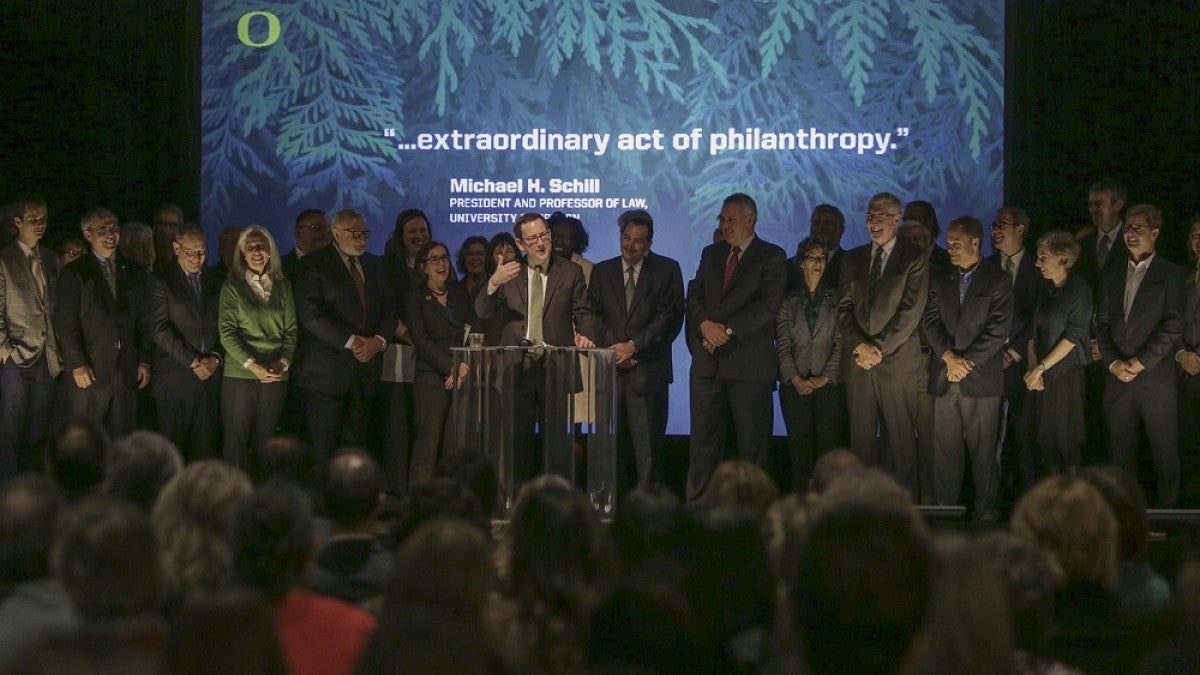 President Schill at podium surrounded by supporters