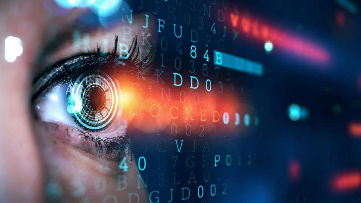 Stock image of an eye scanning computer code