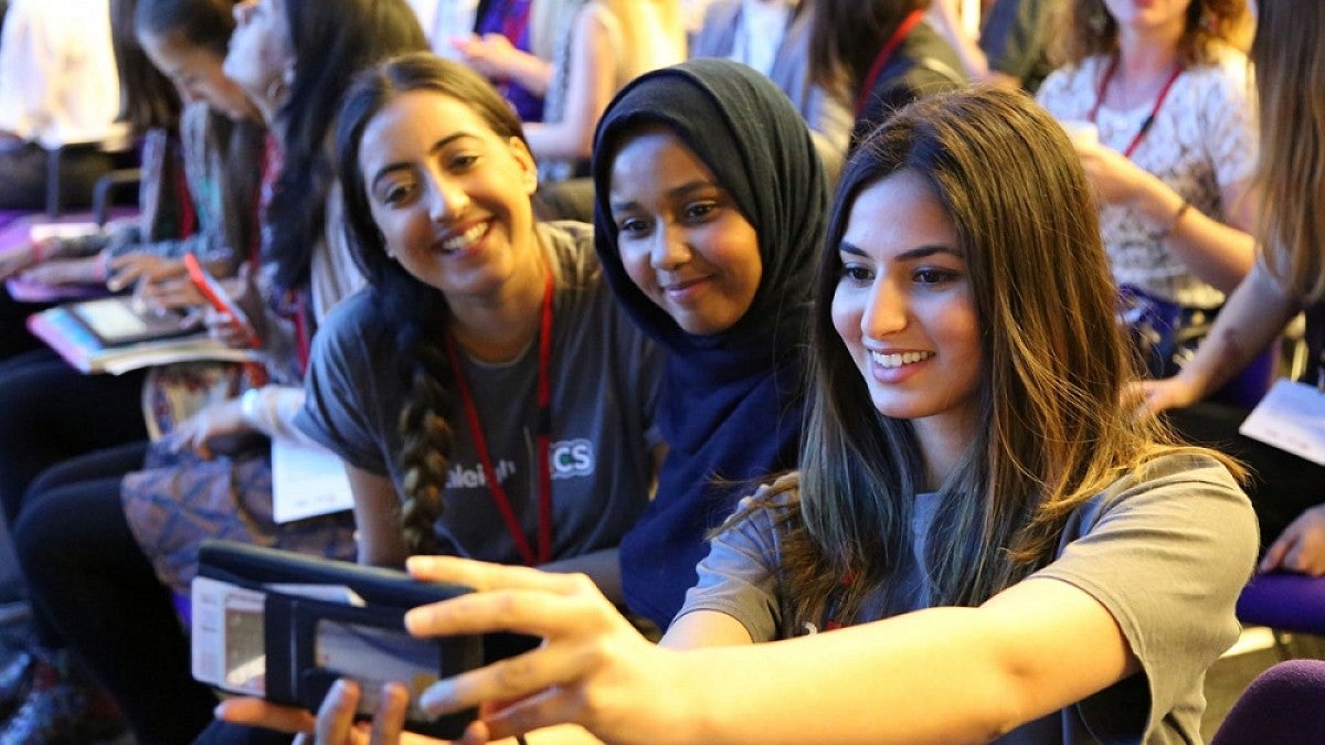 Girls using technology at a conference in London in 2016