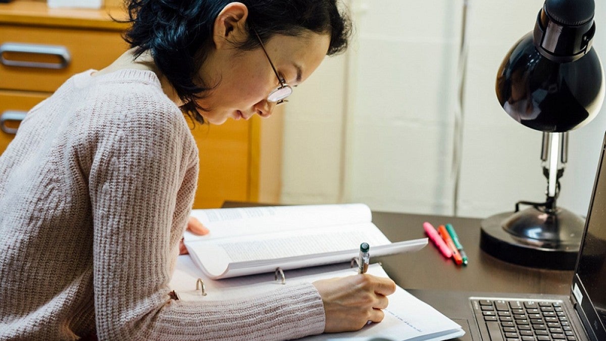 Woman writing at desk