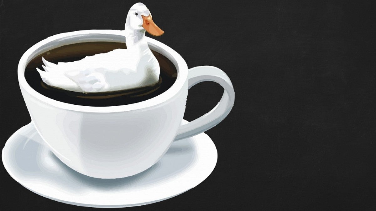 Image of a duck floating in a coffee cup