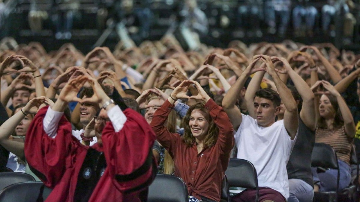 Crowd throwing the O