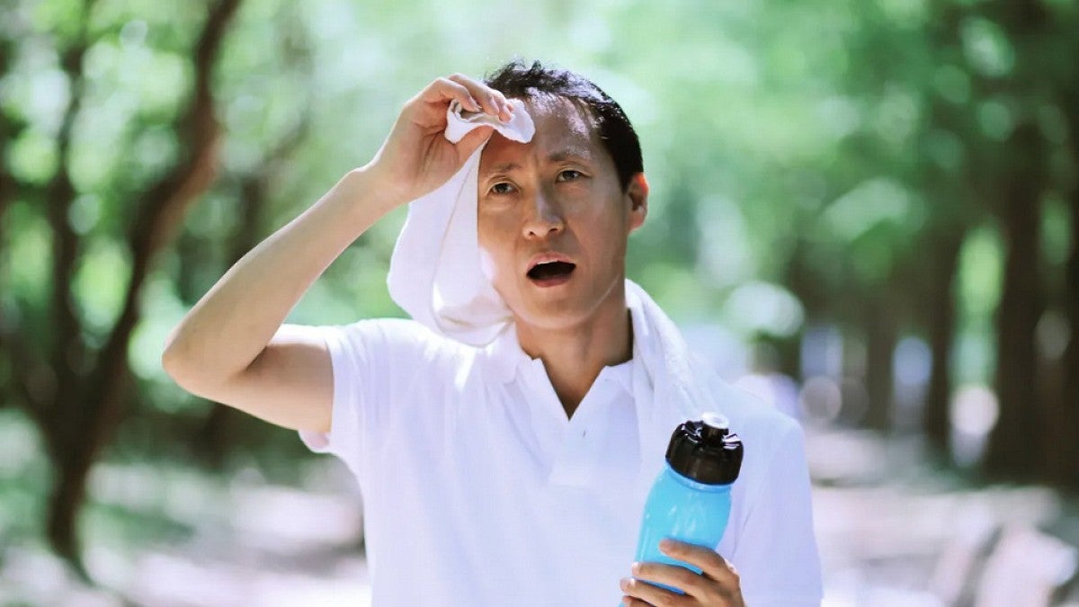 Man wiping sweat from his brow