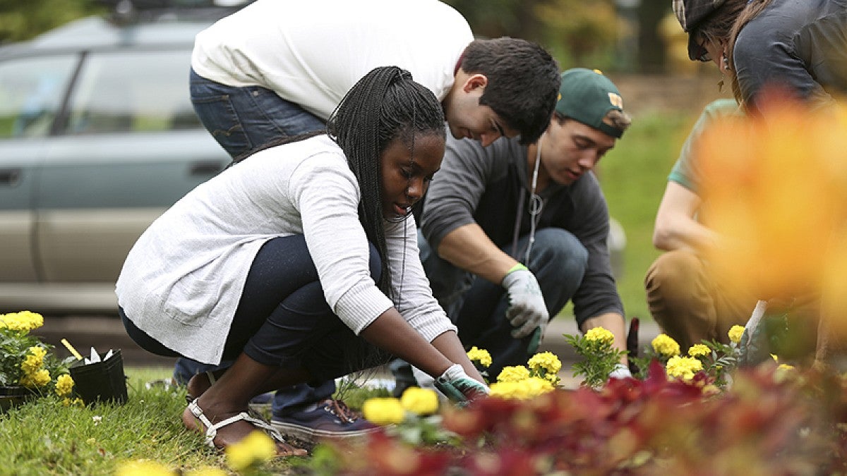 Students planting flowers on Earth Day