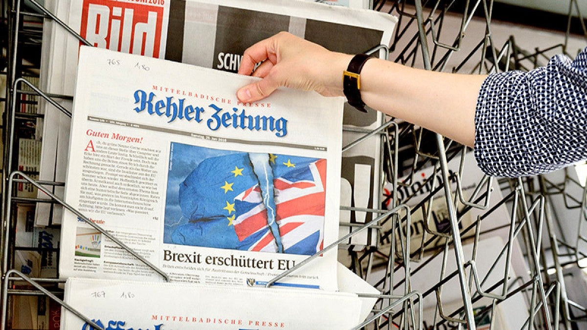 Person holding up a German newspaper