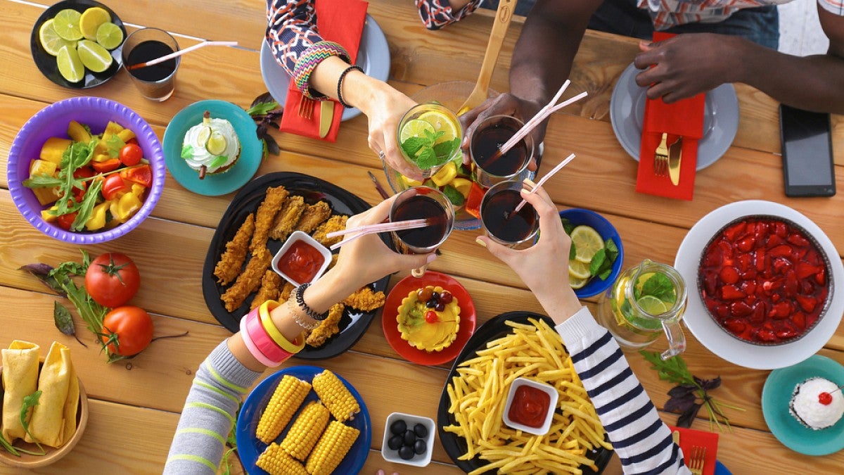 People at table reaching for food