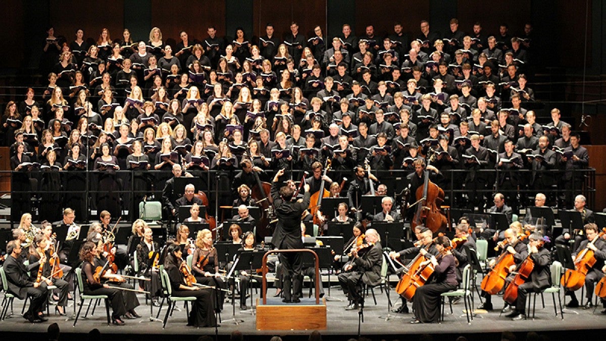 Matthew Halls conducting an orchestra and chorus at the the Oregon Bach Festival.