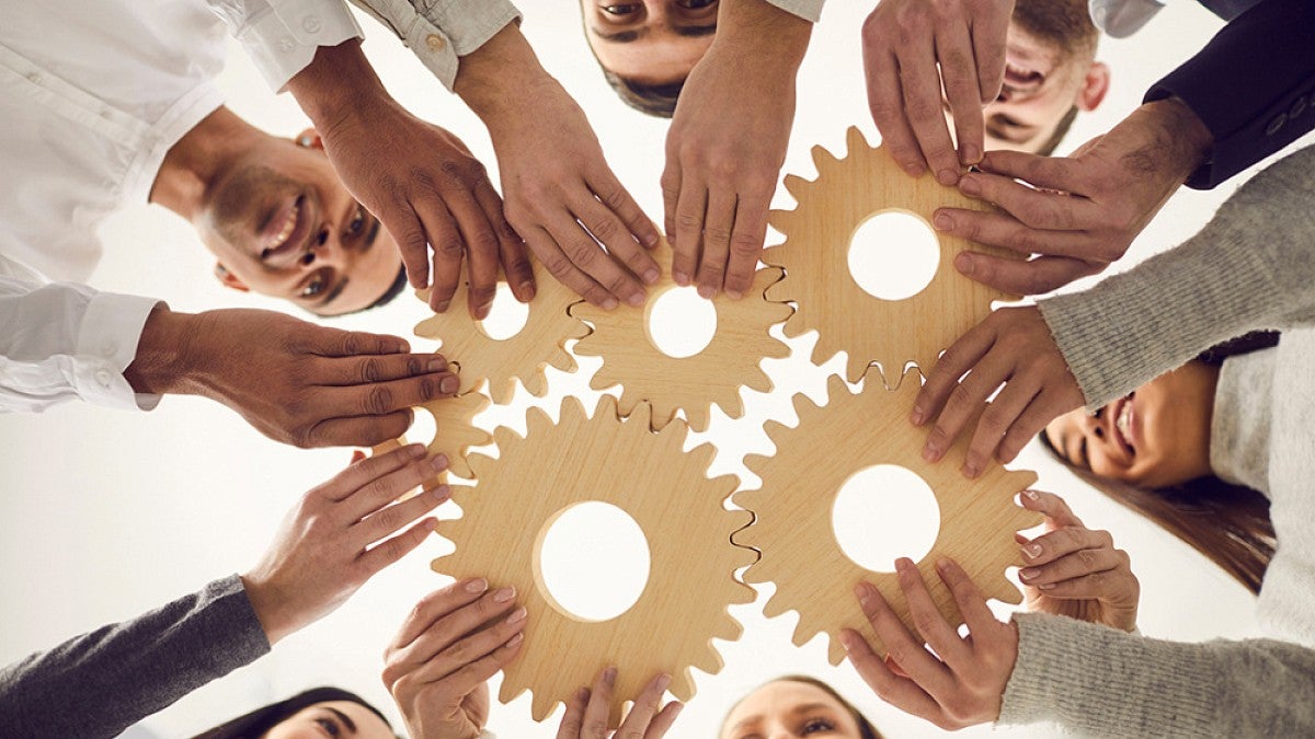 People holding cogwheels