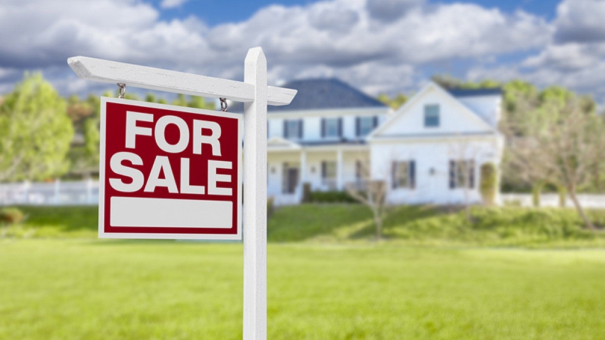 For Sale sign in front of home