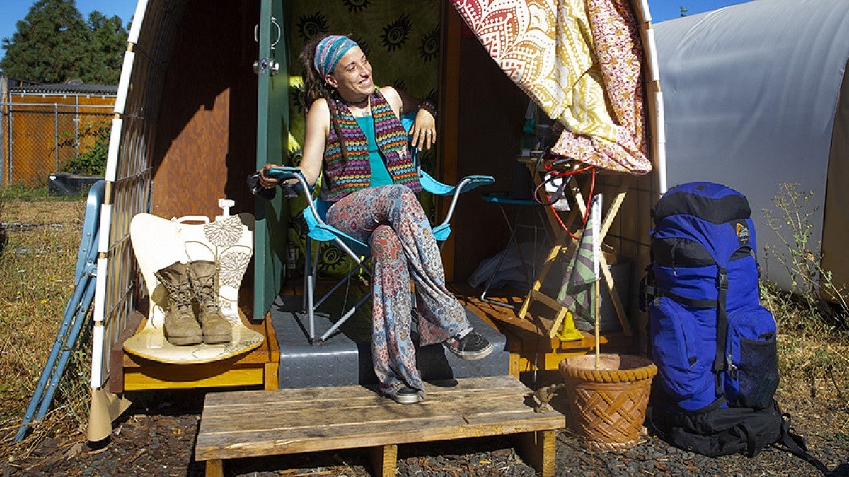  Jourdan Horton outside a Conestoga hut temporary shelter