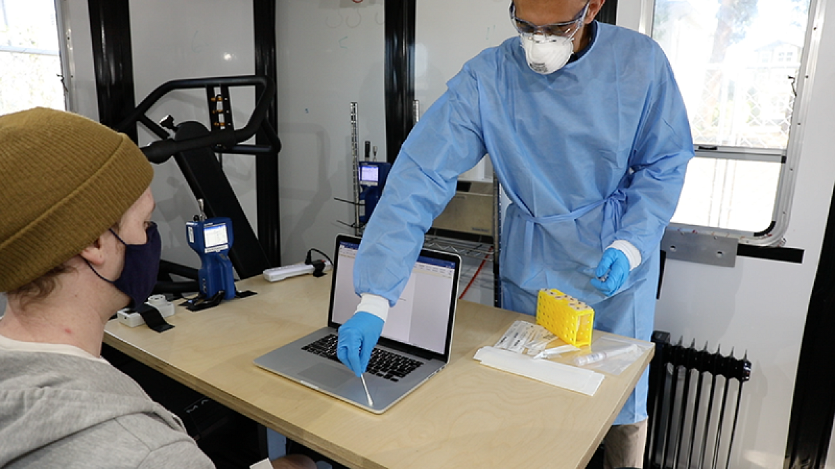 Researcher collecting a sample from a laptop