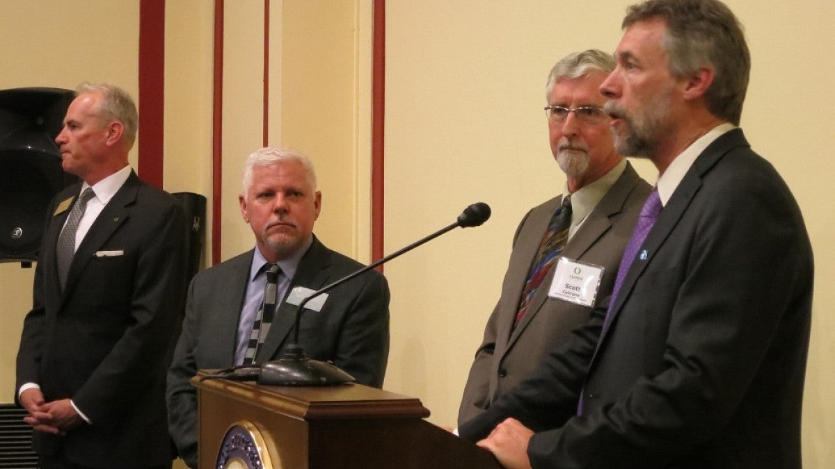 Brad Shelton, Scott Coltrane (at podium) and Randy Kamphaus (far left)