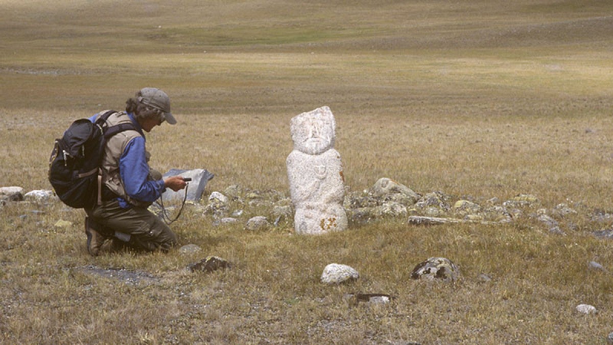 UO professor Esther Jacobson-Tepfer recording an image stone from the Turkic period in the valley of Postigiin Gol. (Photo: Gary Tepfer)