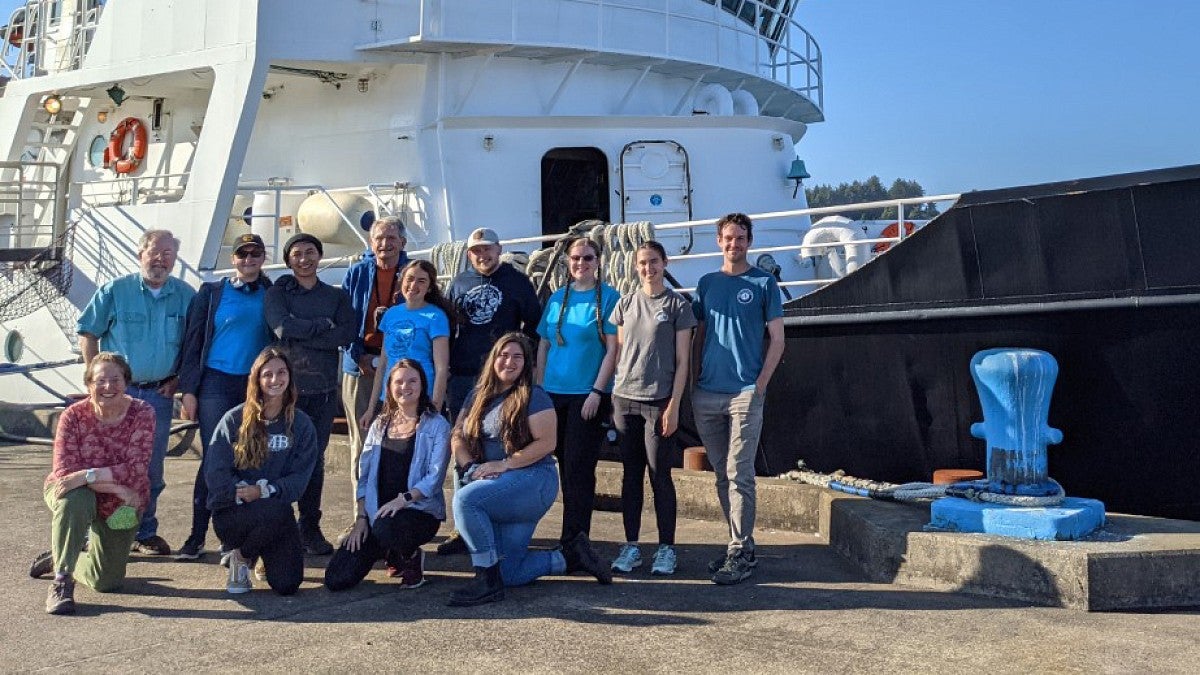 Oceanus crew on dock in front of ship