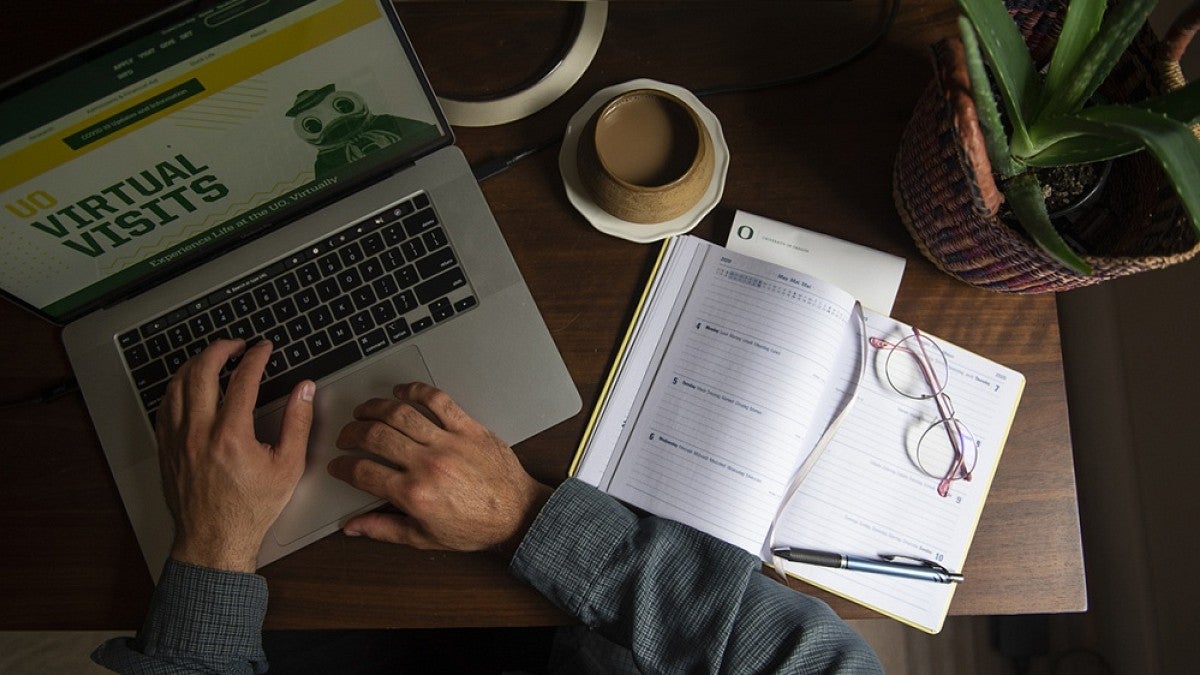 Overhead view of man working at laptop