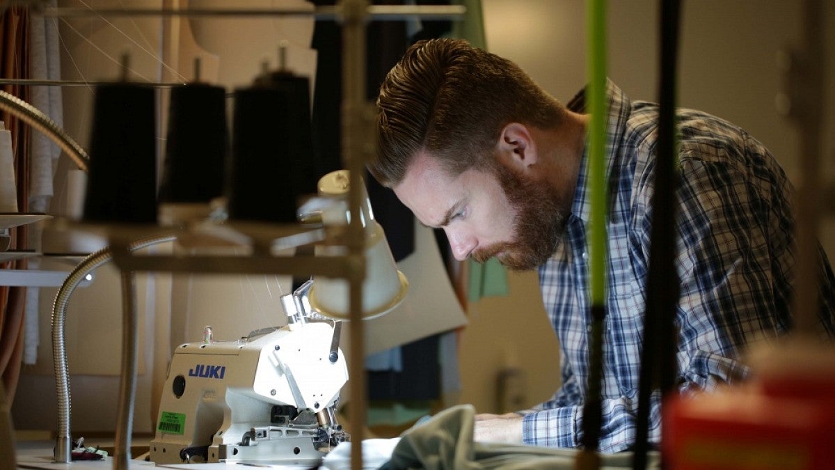 David Parkinson working at a sewing machine