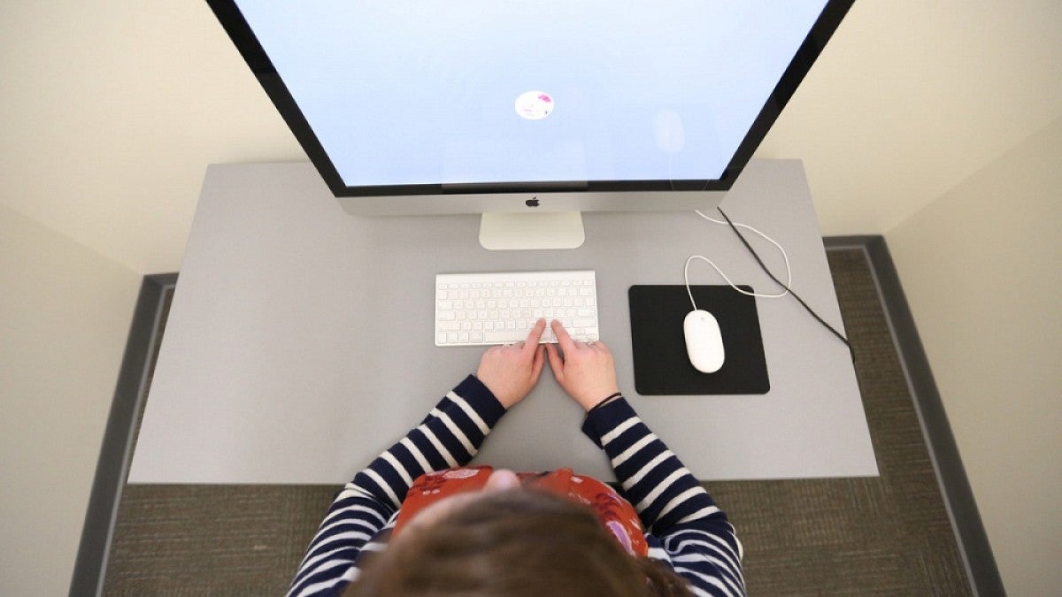 Overhead view of a person in front of a computer screen