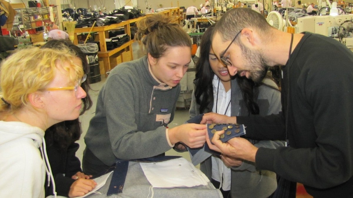 Students examine clothing