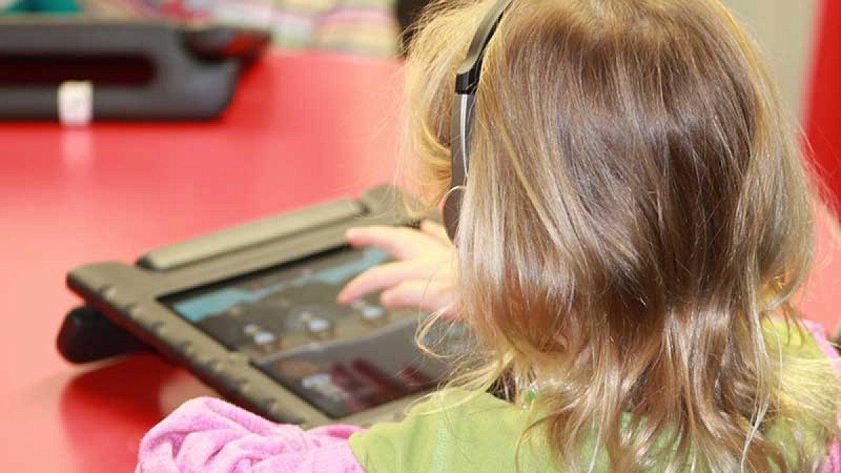 Child working on computer tablet