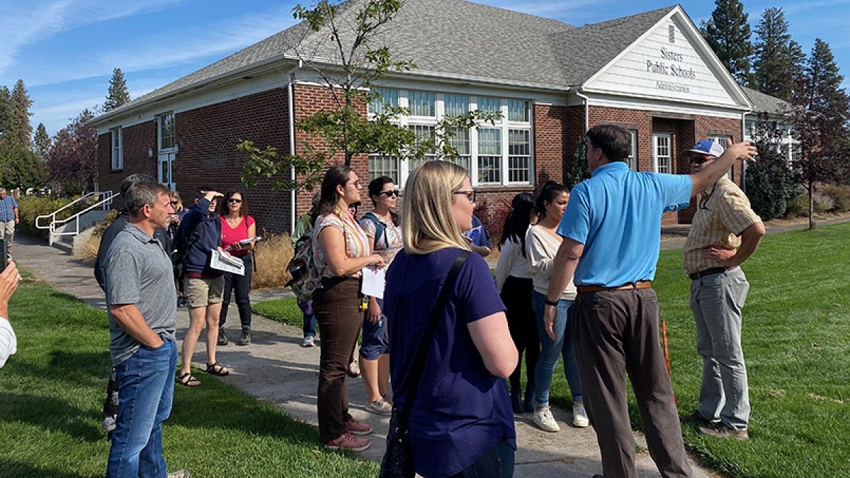 People at Sisters school site