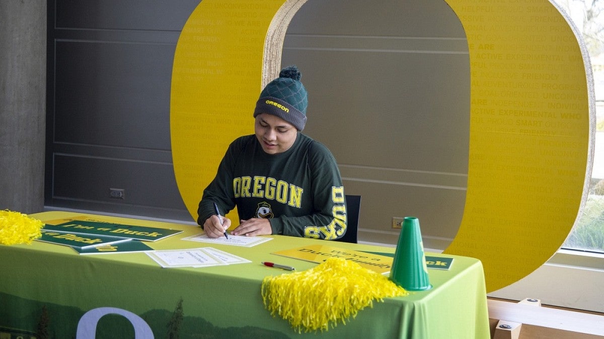 Student signing enrollment form