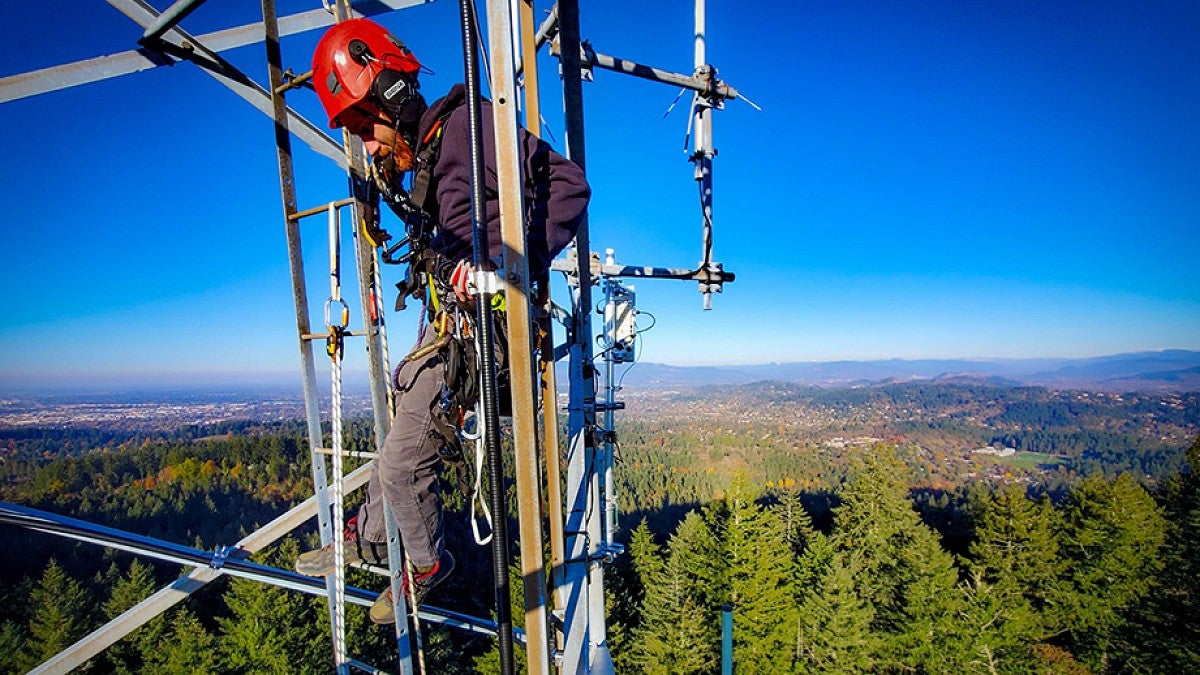 Climber on communications tower