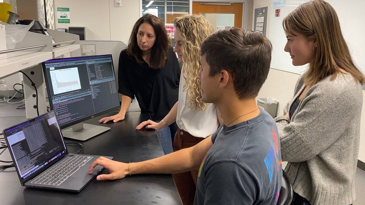 Professor and students in lab