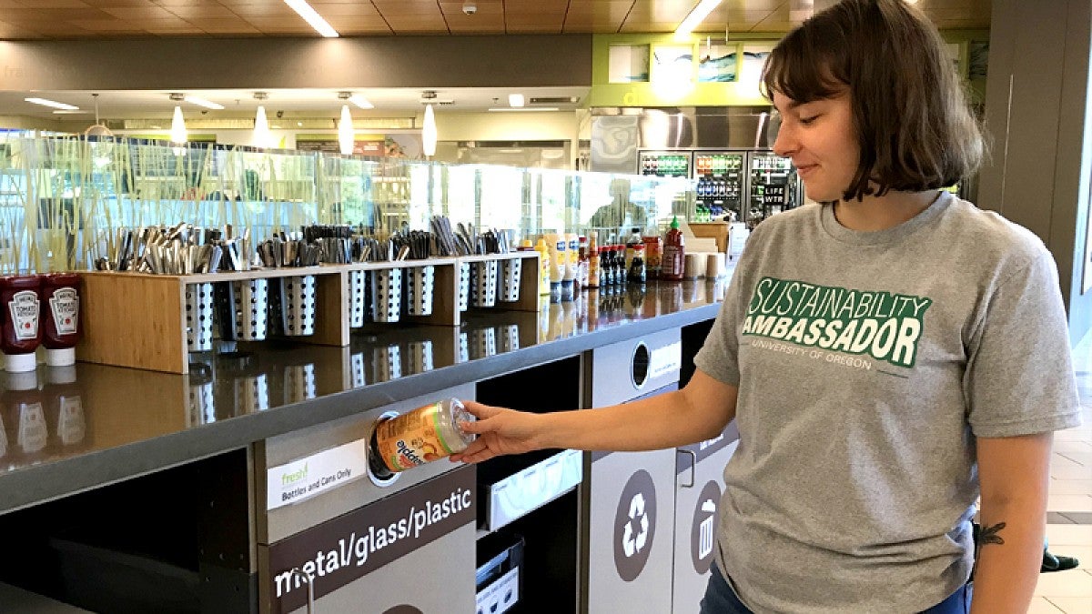 Woman recycling a soda can