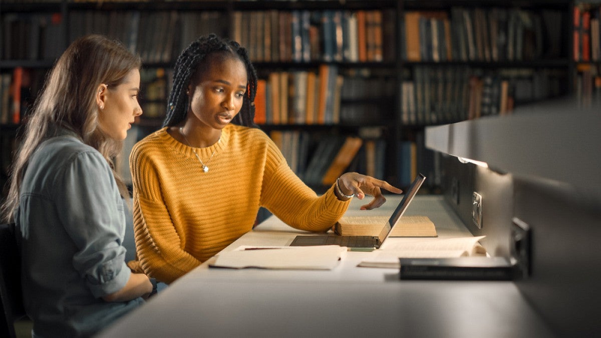 Teens studying in library