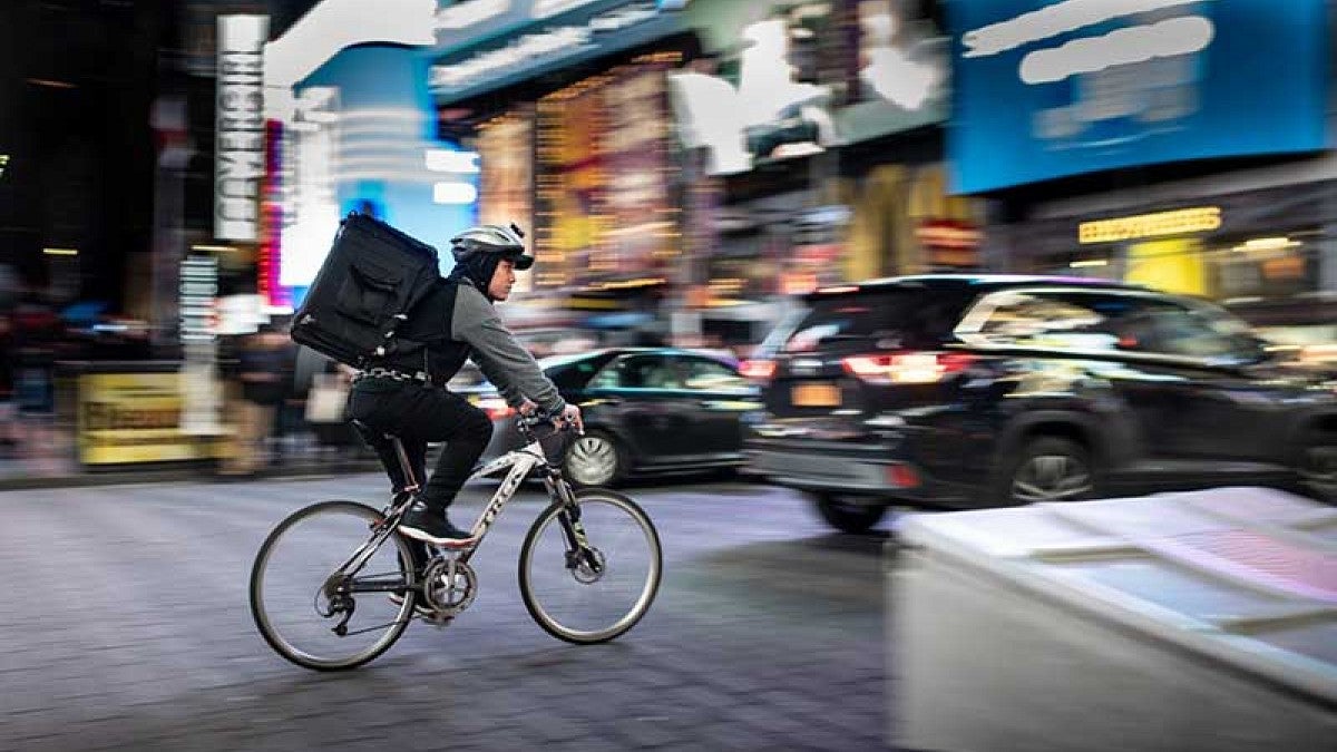 Bicycle delivery person on city street