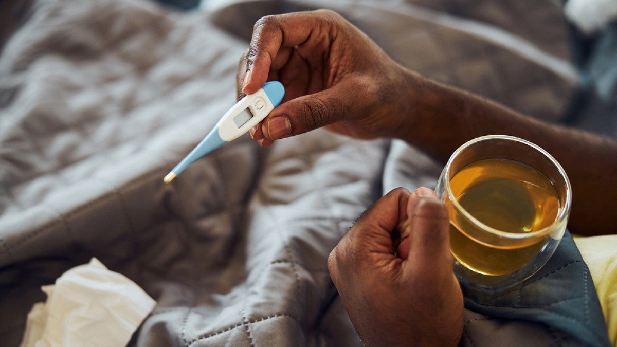 Person holding thermometer