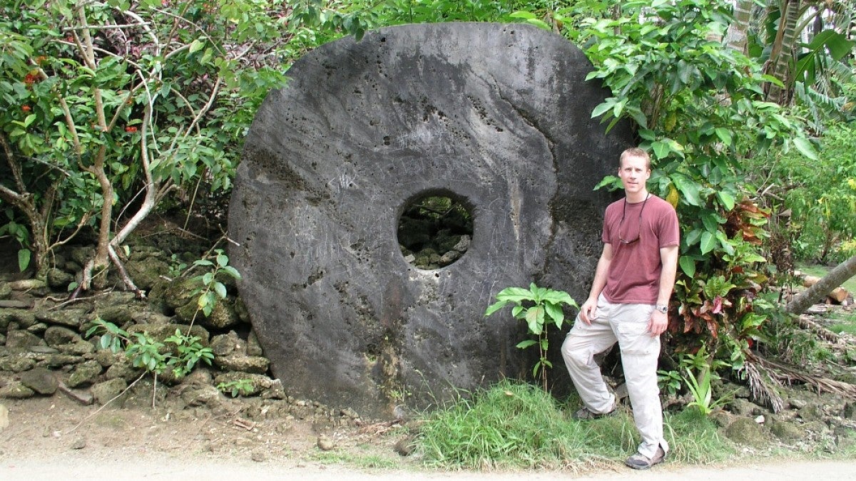 Archaeologist Scott Fitzpatrick with an example of rai on the island of Yap