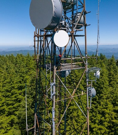 A man is shown climbing a tower