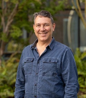 Paul Dalton outside with trees in the background