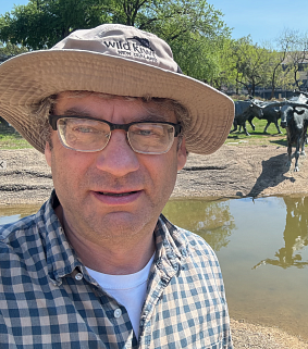 Ilya Bindeman outside with animals in the background