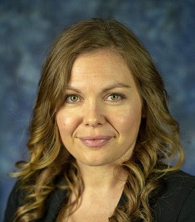 picture of Laura Wellman with a dark blue backdrop