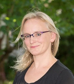 Jennifer Ruef standing outside with trees behind her