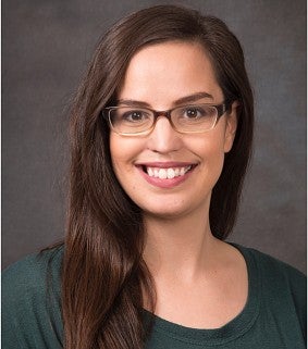 Melanie Spero smiling inside wearing a green top