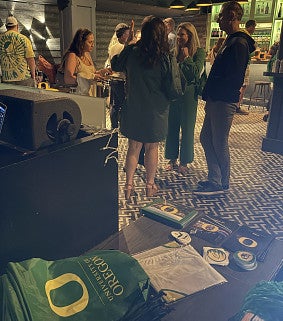 student and alumni interacting at a UO event