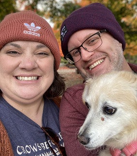Tate, with husband Adam and their dog, Harvey, credits her success in part to flexible work arrangements
