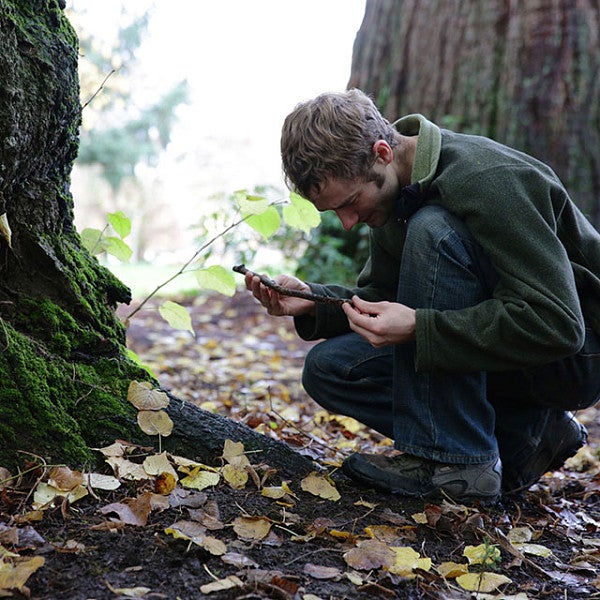 Aaron Nelson examining a stick