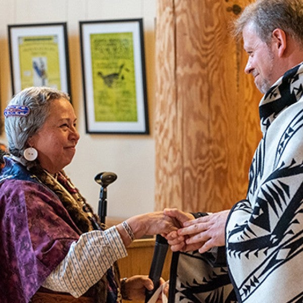 Bobbie Conner, director of the Tamástslikt Cultural Institute, presented a blanket to UO law professor Michael Moffitt at the Many Nations Longhouse on June 3, 2022.
